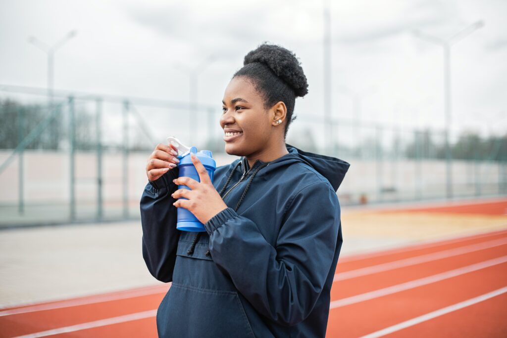 woman-drinking-water-at-track